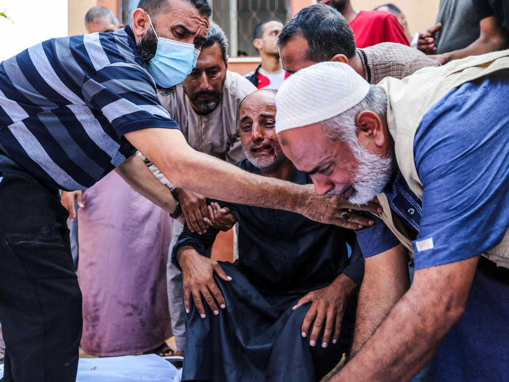 People mourn as they collect the bodies of Palestinians killed in Israeli air raids on Nov. 5, 2023 in Khan Younis, Gaza.