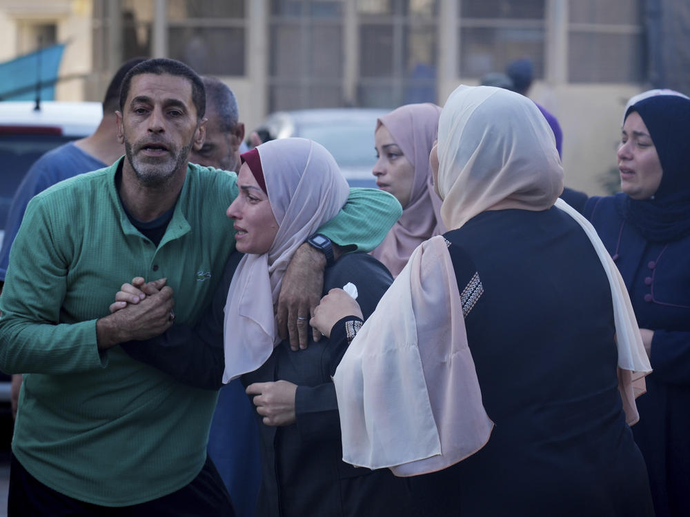 Palestinians mourn relatives killed in the Israeli bombardment of the Gaza Strip in front of the morgue in Deir al Balah on Monday.