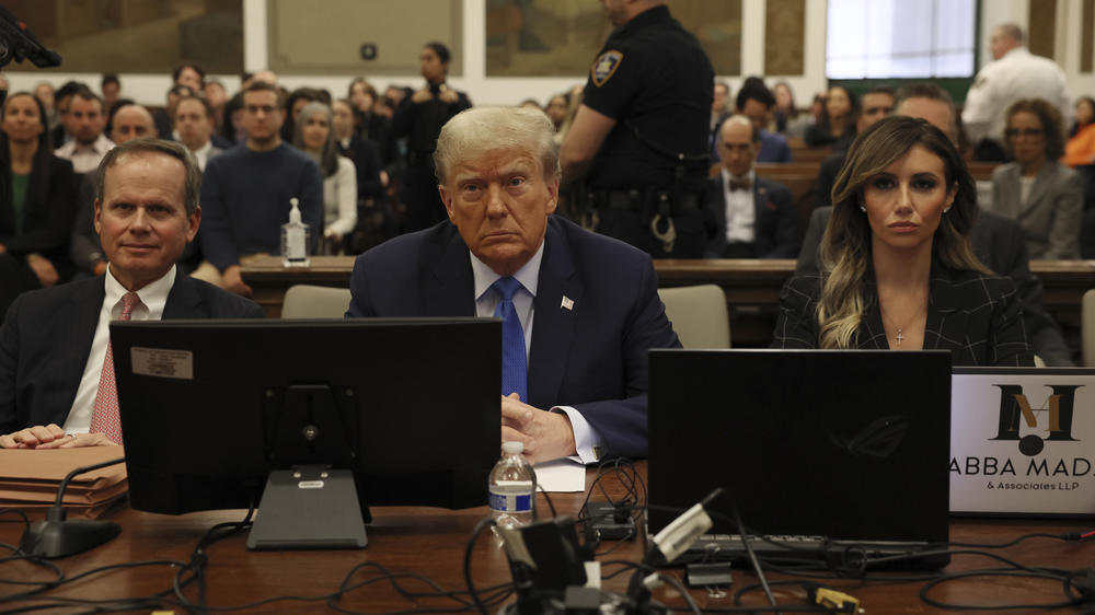Former President Donald Trump, center, waits to take the witness stand at New York Supreme Court on Monday.