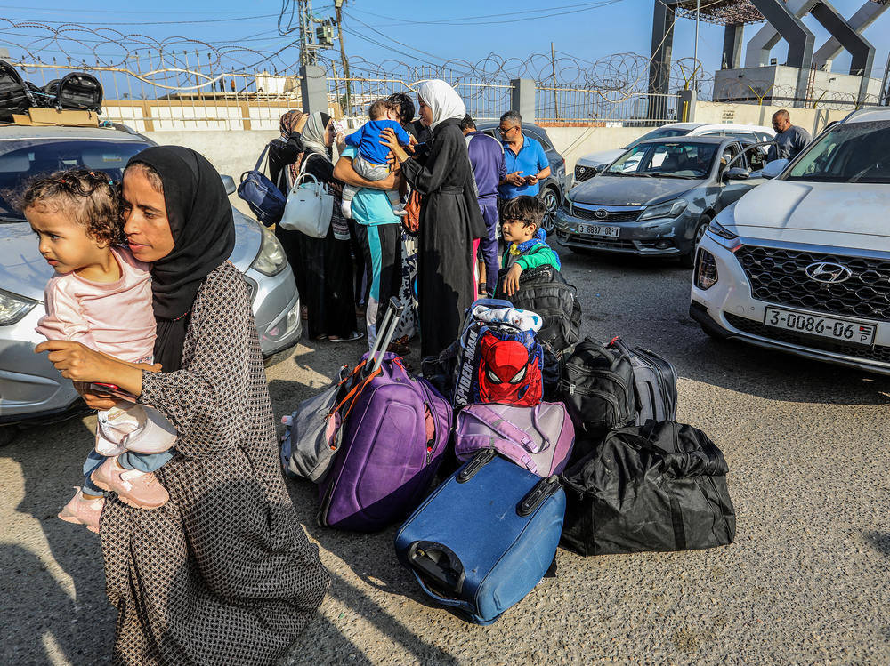 Palestinians with foreign passports at Rafah Border Gate wait to cross into Egypt, Nov. 1.