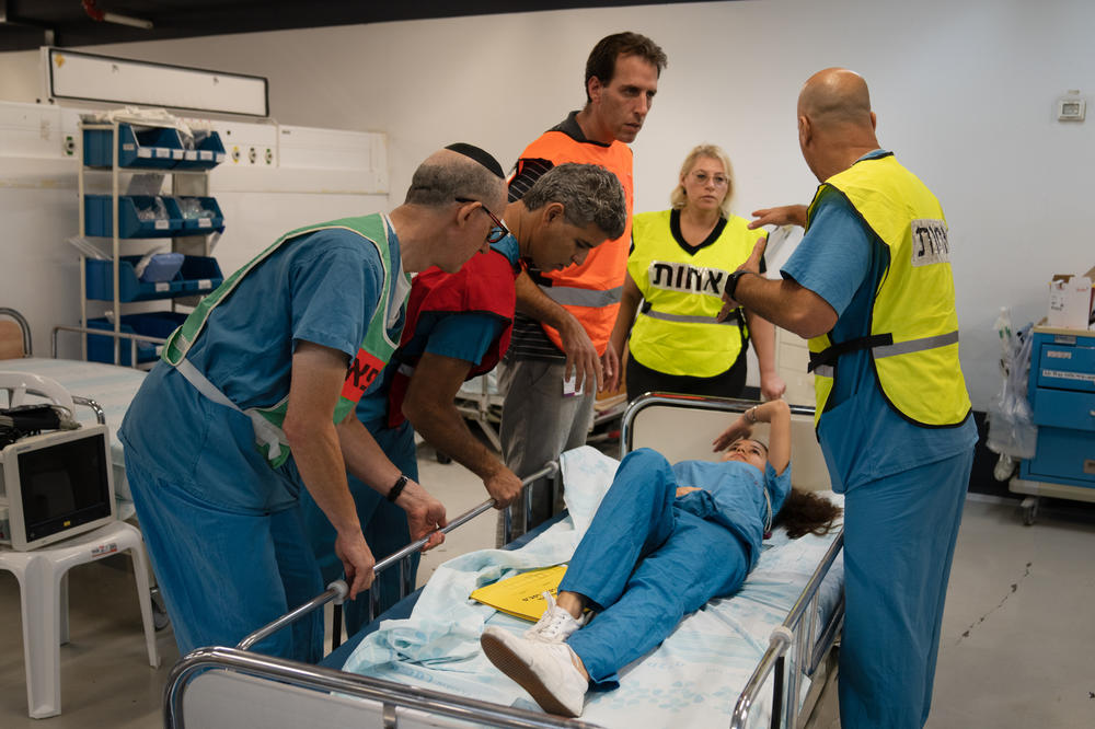 A team of hospital employees runs through a drill to practice in the underground hospital in Haifa.