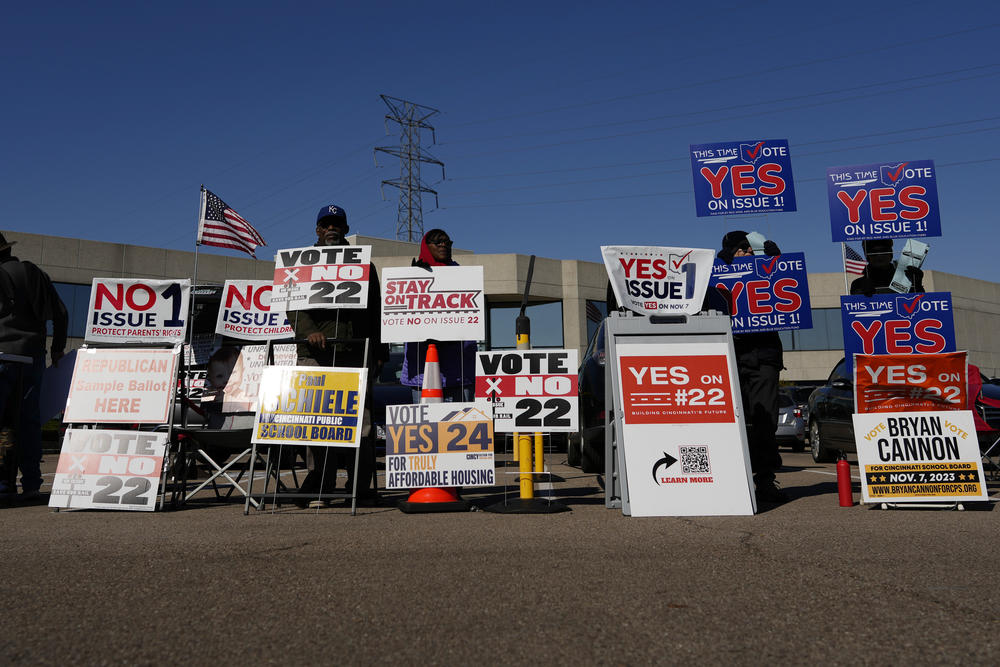 People gather in the parking lot of the Hamilton County Board of Elections as people arrive for early in-person voting in Cincinnati, on Nov. 2.
