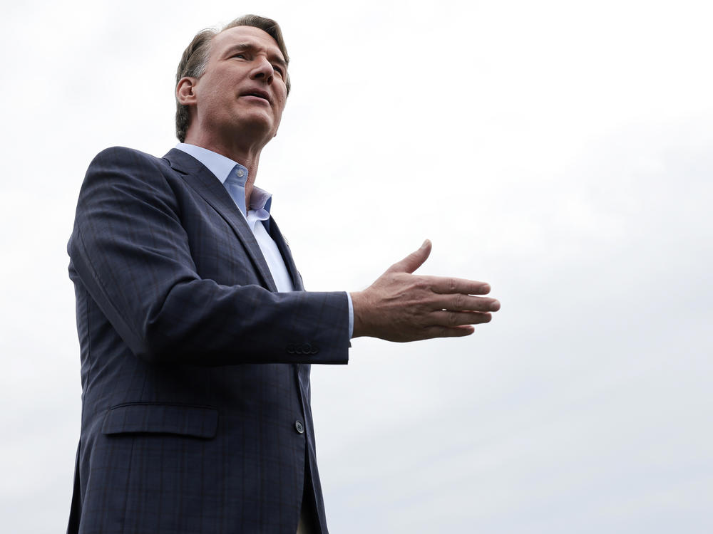Virginia Gov. Glenn Youngkin answers questions from members of the media while campaigning at Piney Branch Elementary School on Tuesday in Bristow, Va.