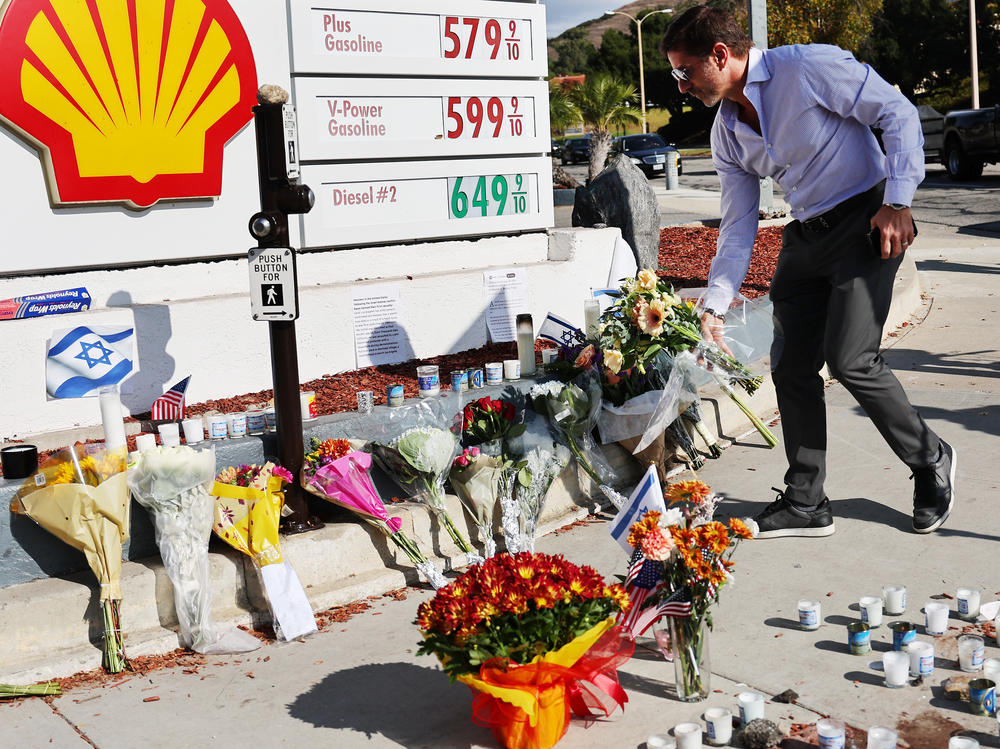 A person places flowers on Tuesday at a makeshift memorial marking the site of the altercation that led to Kessler's death.