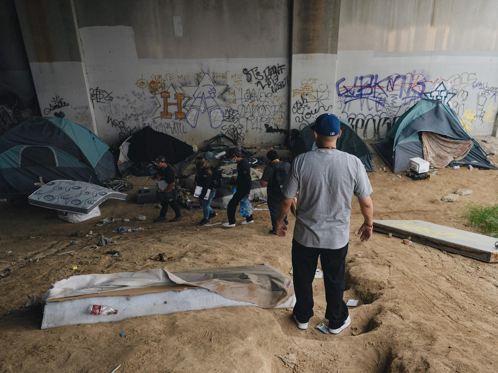 At an encampment under a South L.A. highway, there are 