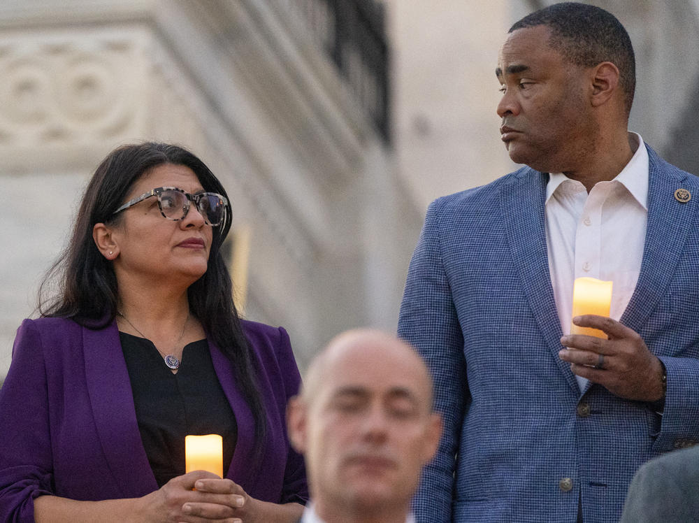 Rep. Rashida Tlaib, D-Mich., left, and Rep. Marc Veasey, D-Texas, stand with candles as members of Congress hold a candlelight vigil for Israel on the steps of the U.S. House of Representatives, Tuesday, Nov. 7, 2023, in Washington.