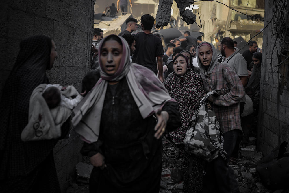 Destruction and chaos caused by Israeli attacks on Al-Maghazi refugee camp in Deir al-Balah, Gaza, on Monday.