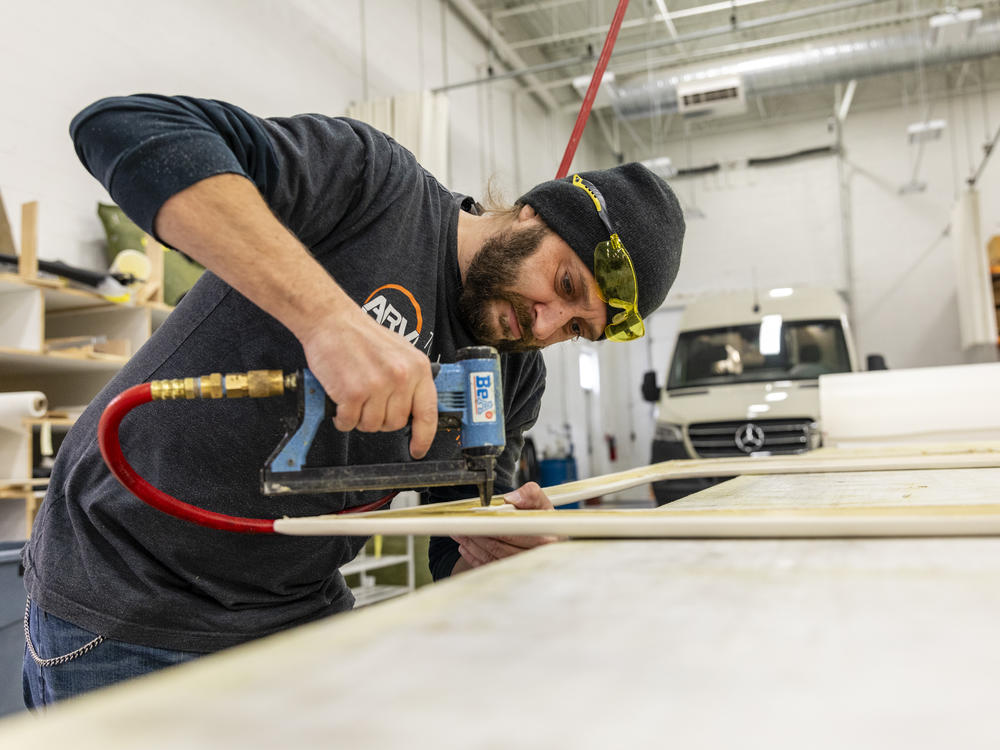 Bill Kowalcic works on wall panels in the finishing department at Advanced RV. After the company went to a four-day workweek, his team figured out how to cut time without cutting corners.