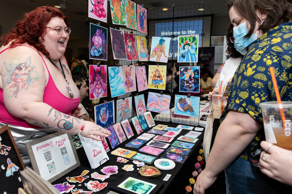 Vendor Ashley Obenstine, who runs 'Obeillustration,' sells their work to attendees at Philly FatCon on Oct. 28. Obenstine was one of the vendors in the marketplace that included people selling art, jewelry, clothing and more.