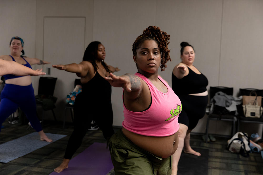 Queen Nzinga (center) during the breathe and flow yoga class at Philly FatCon in October. The class started with breathing exercises while instructor Laura Zales spoke to attendees about taking up space.