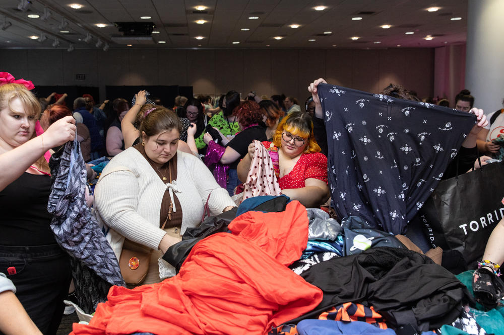 Attendees look through clothing at the third annual Plus Size Swap + Shop event during Philly FatCon last month. The tables were labeled by size, ranging from Xl-6X or size 14-32. Attendees had to bring 5-20 items of good condition clothing to participate.
