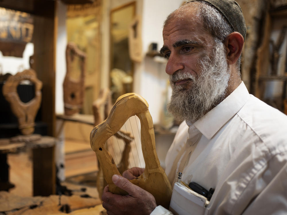 Itay Levy makes music and Kinnors — intricately-carved wooden harps.