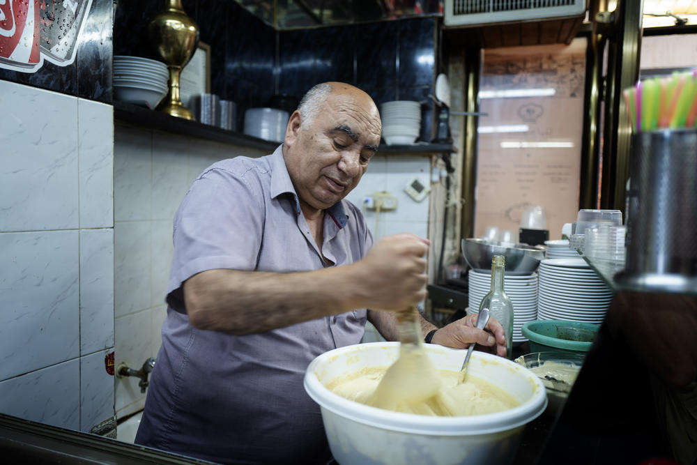 Ghaleb Abdulfatah Zahdy makes hummus.