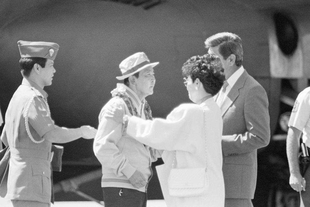 Exiled former Philippine President Ferdinand Marcos receives a warm welcome from then-Hawaii Gov. George Ariyoshi and his wife Jean as Marcos and his family arrived on Feb. 26, 1986, in Honolulu.