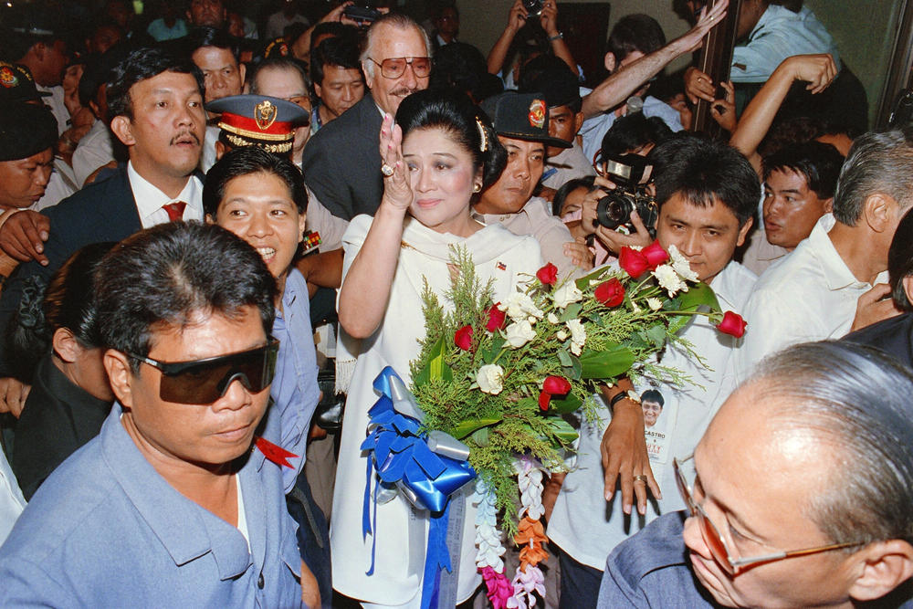 The former first lady of the Philippines, Imelda Marcos (center), accompanied by her son Ferdinand 