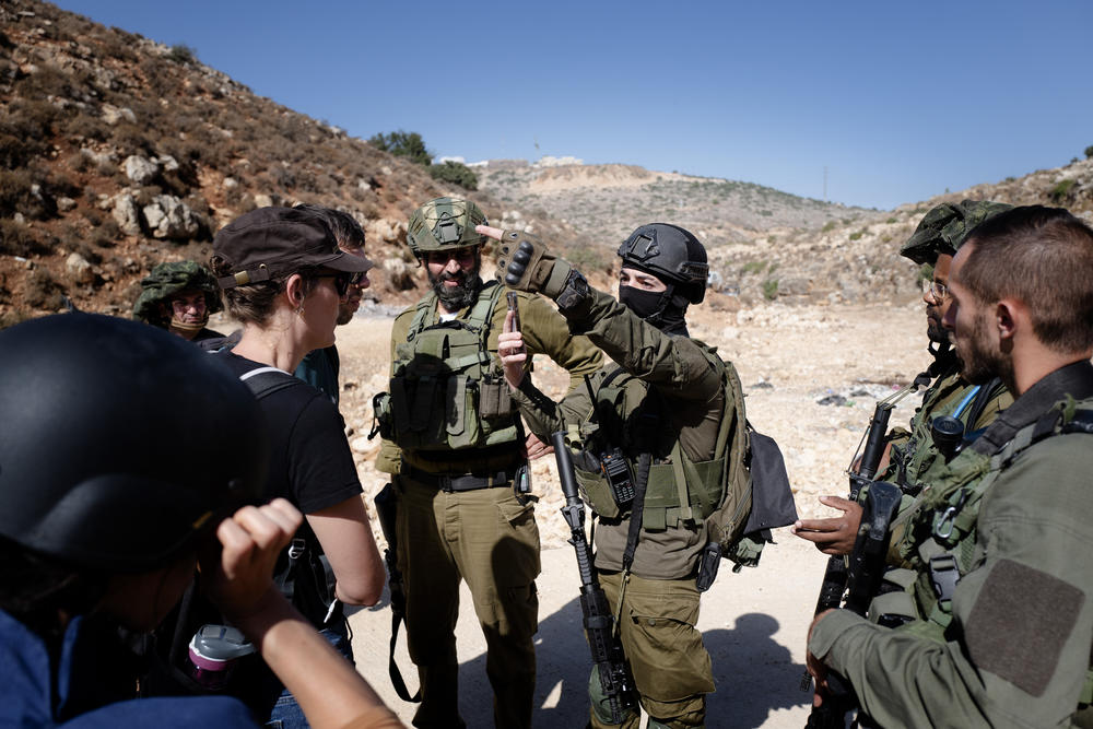 Israeli forces confront the NPR team and Rabbis for Human Rights.