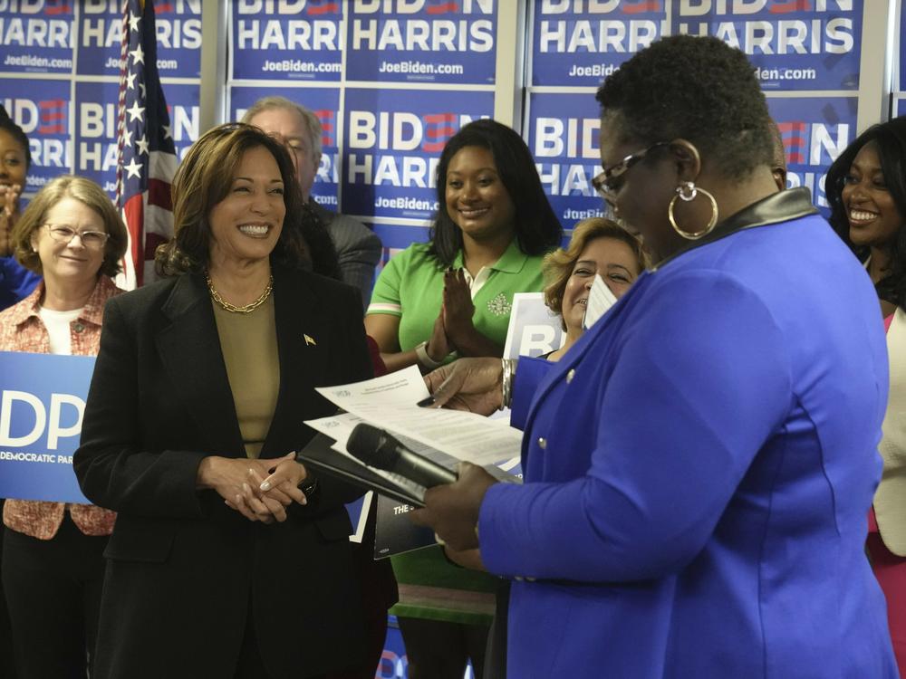 Vice President Harris smiles as South Carolina Democratic Party chair Christale Spain accepts President Biden's paperwork for the state's Democratic presidential primary.