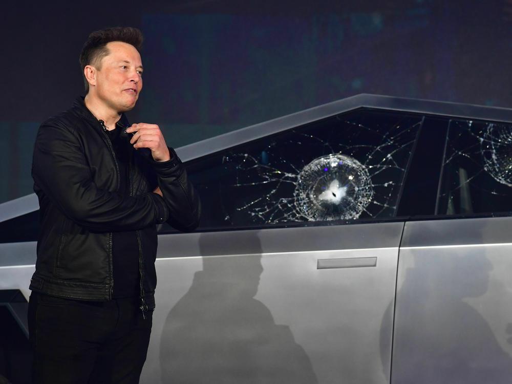 Tesla co-founder and CEO Elon Musk verbally reacts in front of the newly unveiled all-electric battery-powered Tesla Cybertruck with broken glass on windows following a demonstation that did not go as planned on November 21, 2019 at Tesla Design Center in Hawthorne, Calif.