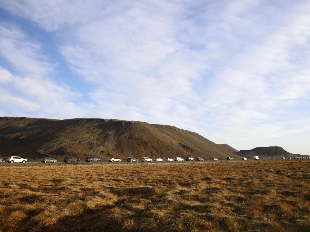 A line of cars queued on a road heading to the town of Grindavik, Iceland, Monday.