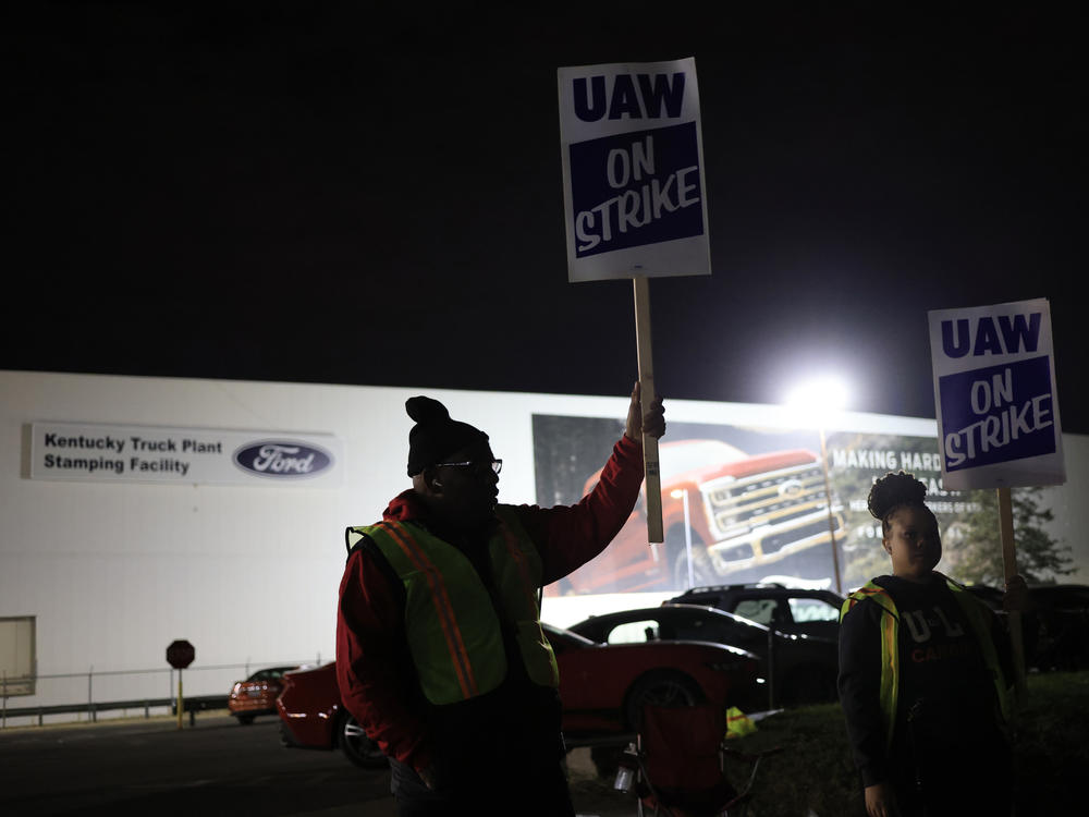 Workers form a picket line outside the Ford Motor Co. Kentucky Truck Plant in the early morning hours on October 12, 2023 in Louisville, Kentucky. This week, a majority of workers at the plant voted no on the tentative contract deal.