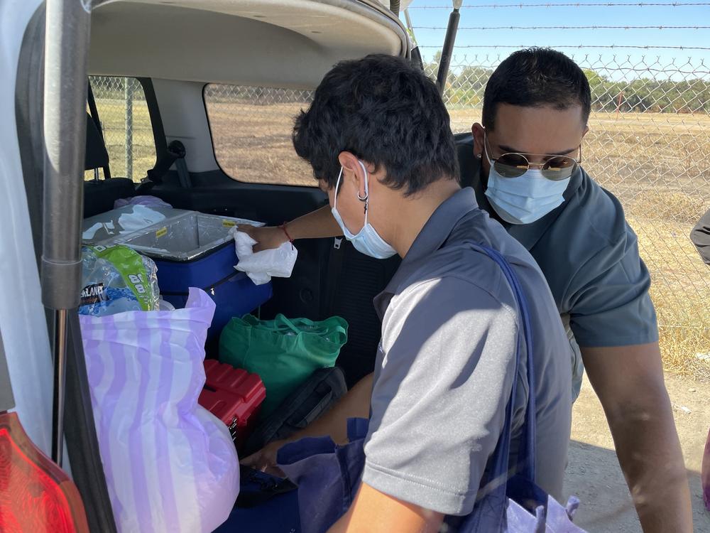 Community health worker Hector Gallegos and nurse Jose Lopez gather supplies to treat homeless patients in Modesto, California.