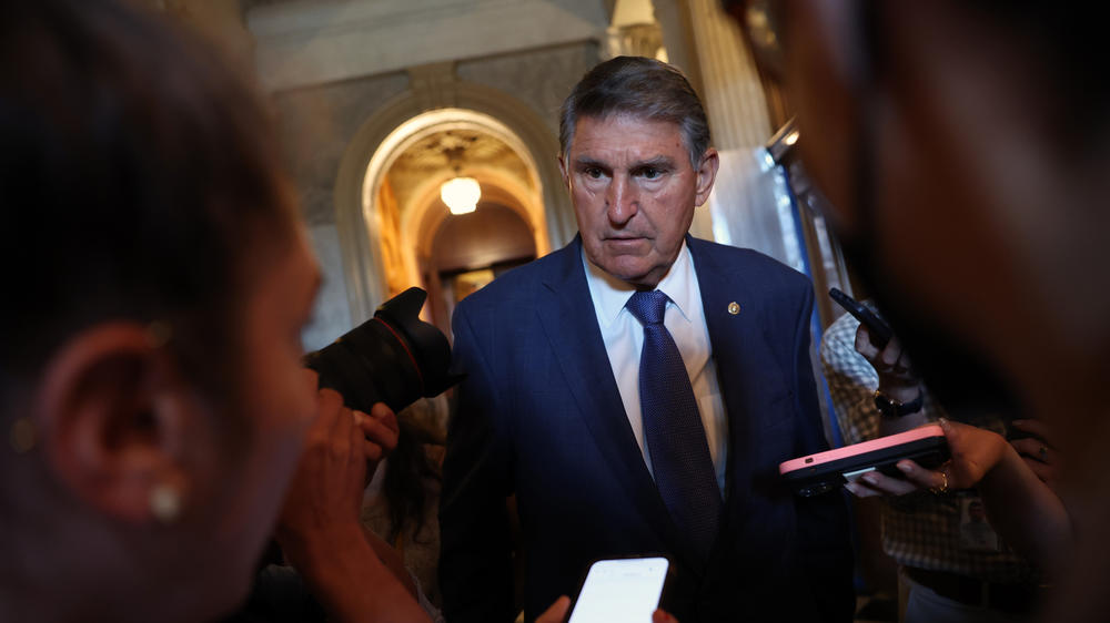 Sen. Joe Manchin, D-W.Va., talks to reporters at the U.S. Capitol in September. Manchin's announcement that he won't seek reelection threatens to imperil Democrats' chances of retaining the Senate.