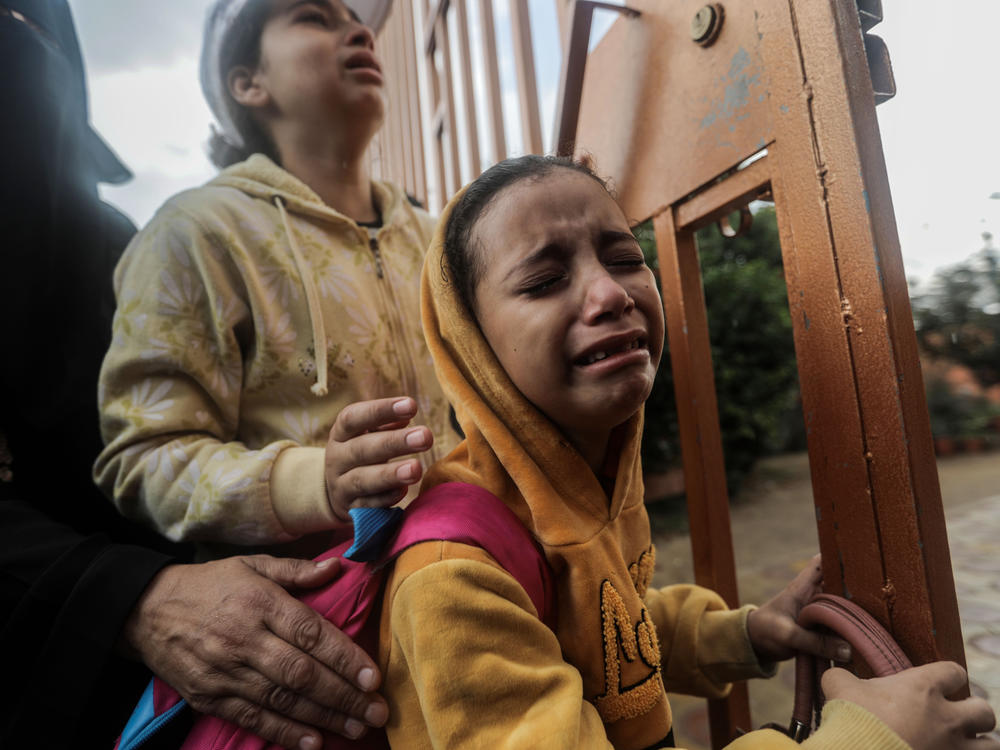People mourn as they collect the bodies of Palestinians killed in Israeli raids on Tuesday in Khan Younis, Gaza.