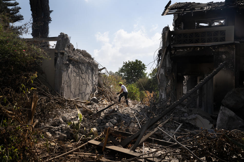 A man working with a search and recovery team from the organization ZAKA look for human remains in Kibbutz Be'eri on Oct. 21.