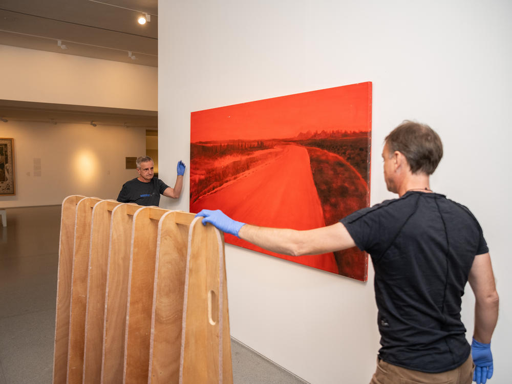 Workers with the Israel Museum hang Ziva Jelin's piece in the Israeli Art wing of the museum.