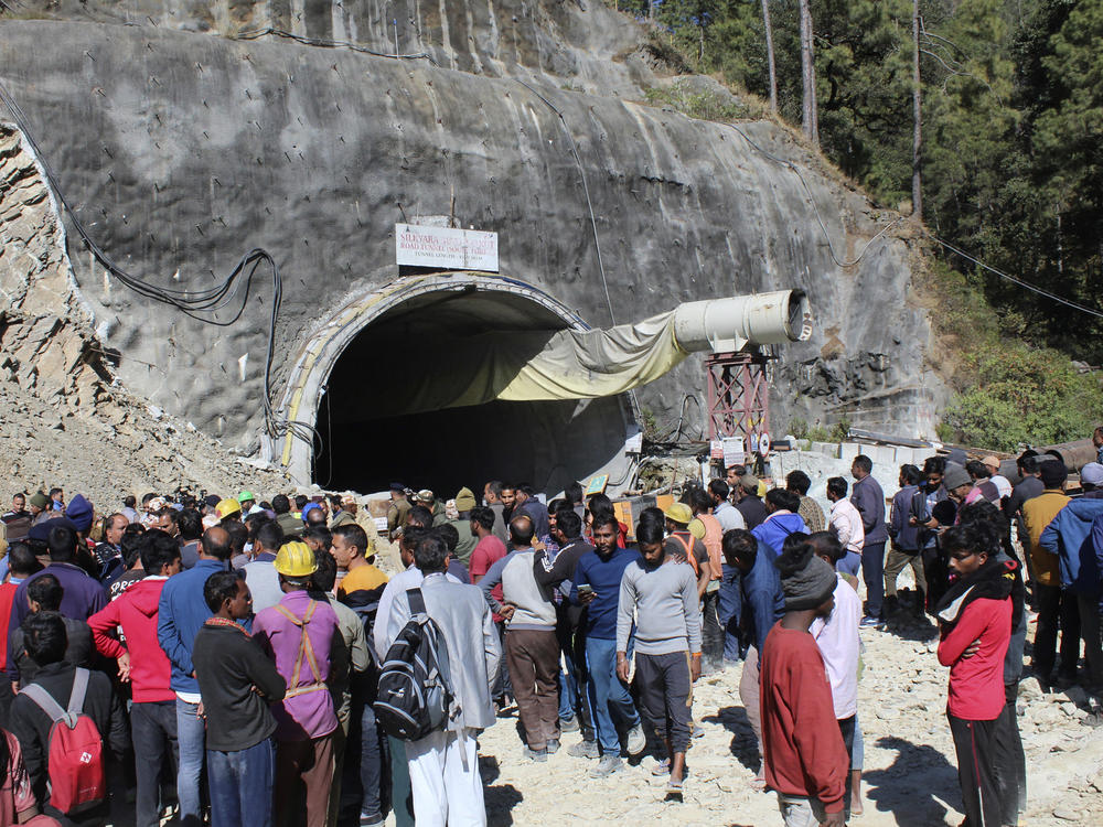 People watch rescue and relief operations at the site of an under-construction road tunnel that collapsed in mountainous Uttarakhand state in India on Wednesday, Nov. 15, 2023. Rescuers have been trying to drill wide pipes through excavated rubble to create a passage to free 40 construction workers trapped since Sunday.