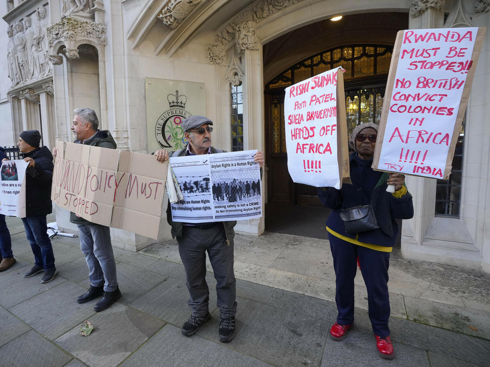 Protesters stand outside the Supreme Court in London on Wednesday.