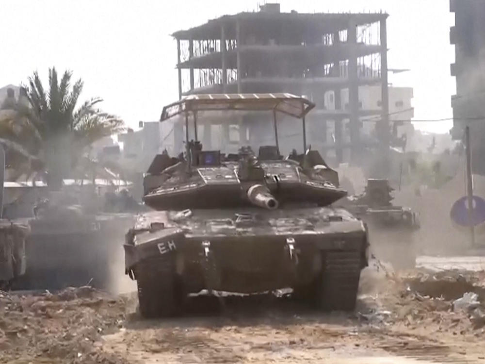 In this image taken from a video released by the Israel Defense Forces on Tuesday, an Israeli tank drives through Gaza City.