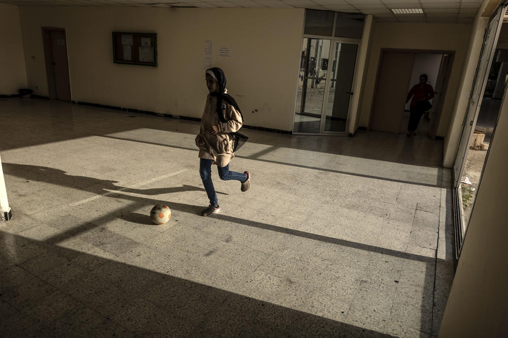 An internally displaced girl plays soccer in a school reconverted as a temporary center for internally displaced people on Oct. 25, in Tyre, Lebanon.