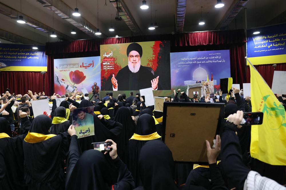 Supporters of Hezbollah watch the its chief Hassan Nasrallah deliver a televised address on a large screen commemorating the annual Hezbollah Martyrs' Day, in Beirut's southern suburbs on Nov. 11.