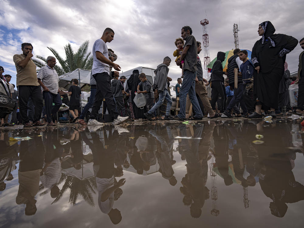 Palestinians displaced by the Israeli bombardment of the Gaza Strip walk in a United Nations Development Programme-provided tent camp in Khan Younis,Nov.15, 2023.