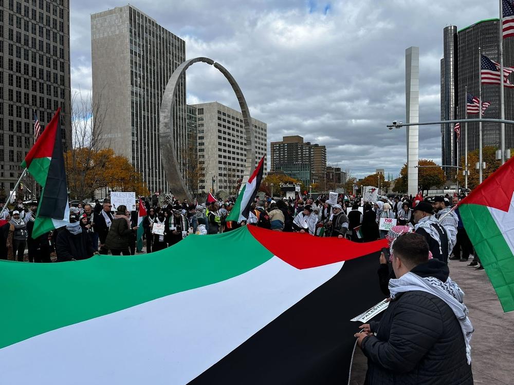 Protesters unfurl a large Palestinian flag at a protest in Detroit.