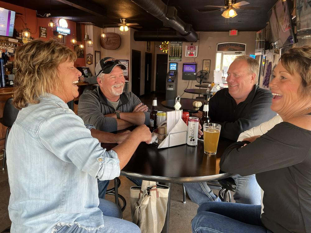 Darla Chaddock (left) and her husband, Rob Chaddock, share a drink with their friends Michelle and Kenny Stone (right) at Judy's Barge Inn in Buffalo, Iowa.