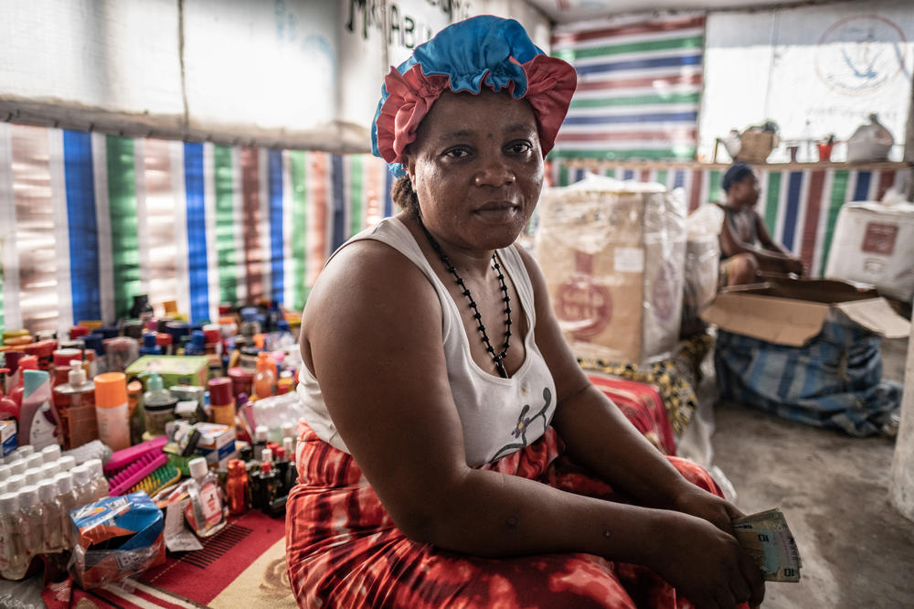 Shopkeeper Tene Kamara, 48, photographed in her shop on Nyangai island, Sierra Leone. Kamara has been building her business here for the past 15 years, but most of her customers have now fled the island as the sea erodes it away. 