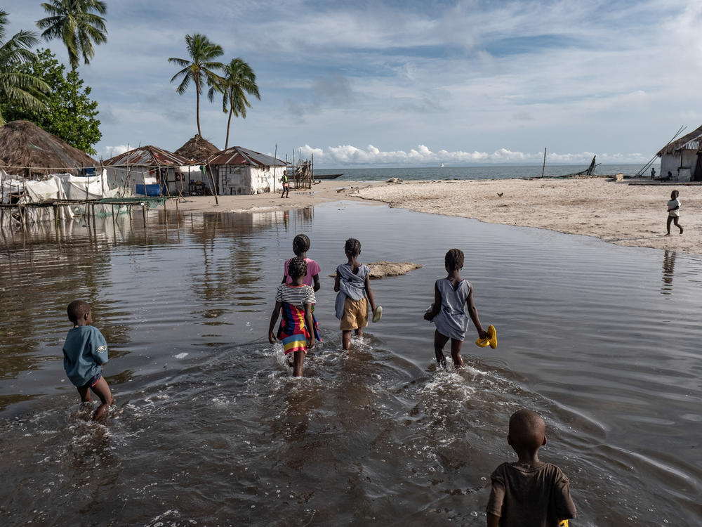 Children wade through floodwater on Nyangai Island, Sierra Leone. Most of the island has already been lost to the sea, and what remains is routinely flooded at high tide.