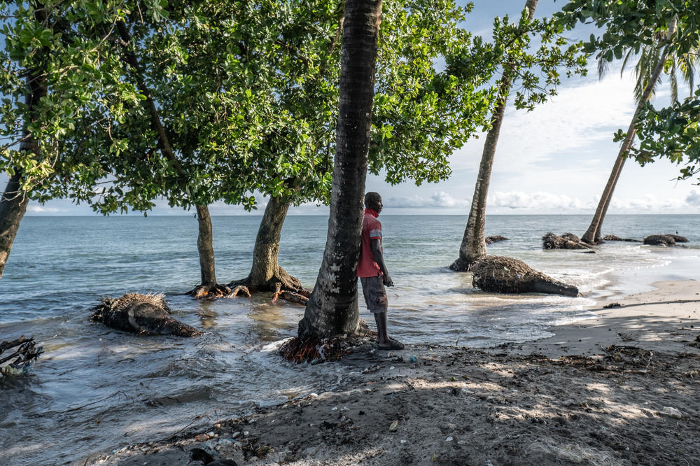 Kpana Charlie, 62, looks on as seawater floods onto Nyangai Island, Sierra Leone. In the span of his lifetime, Charlie has watched the island shrink to just a tiny fraction of its former size as it is swallowed up by the encroaching sea. He believes in as little as two years it may vanish beneath the waves altogether.