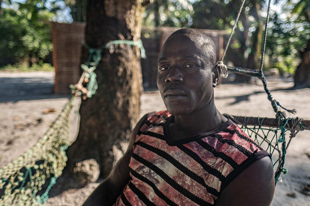 Karim Anso, a 43-year-old refugee from Nyangai Island, photogaphed outside his new home on nearby Sei Island. Anso's family had to rebuild their home four times, fleeing ever further inland as the sea encroached onto Nyangai Island. Eventually, with the island continuing to shrink, he relocated at significant cost.