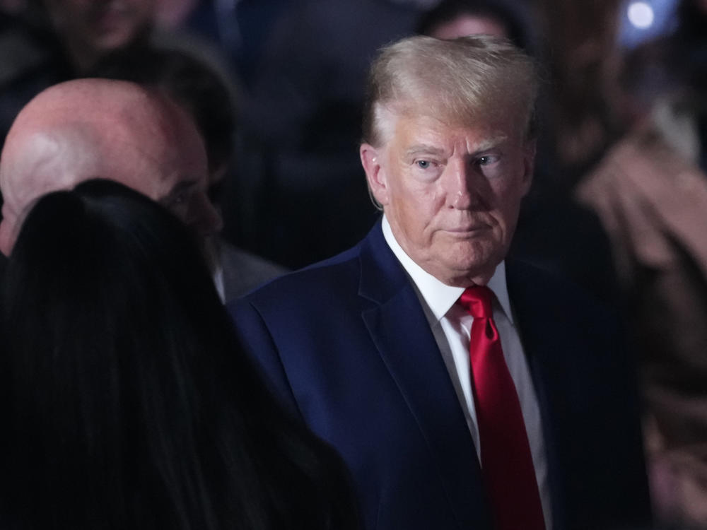 Former President Donald Trump, shown here at a mixed martial arts event on Nov. 11, is asking to be freed from a gag order in an election interference case.