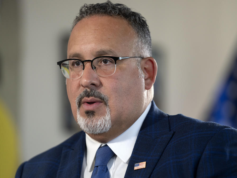 Education Secretary Miguel Cardona speaks during an interview with The Associated Press in his office at the Department of Education, Sept. 20, 2023, in Washington, D.C.