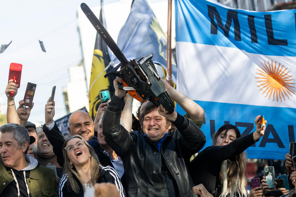 Javier Milei, Liberty Advances coalition presidential candidate, lifts a chainsaw next to his candidate for Buenos Aires Province governor, Carolina Piparo, during a rally in San Martin, Buenos Aires, Argentina.
