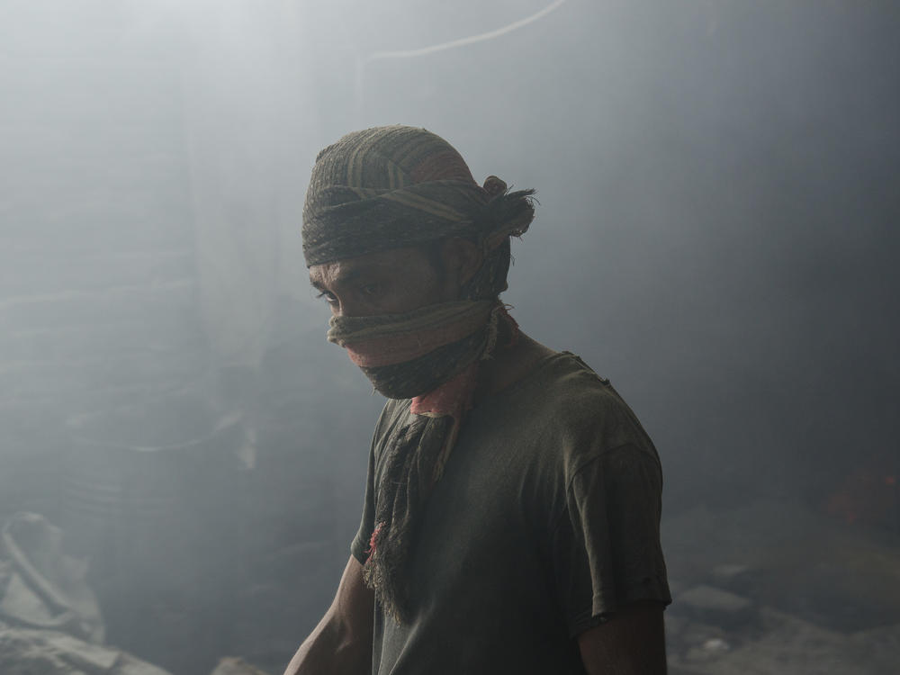 A worker in a Bangladeshi lead mill, without safety protection. A new analysis finds the death toll from lead exposure is about six times higher than the previous estimate.
