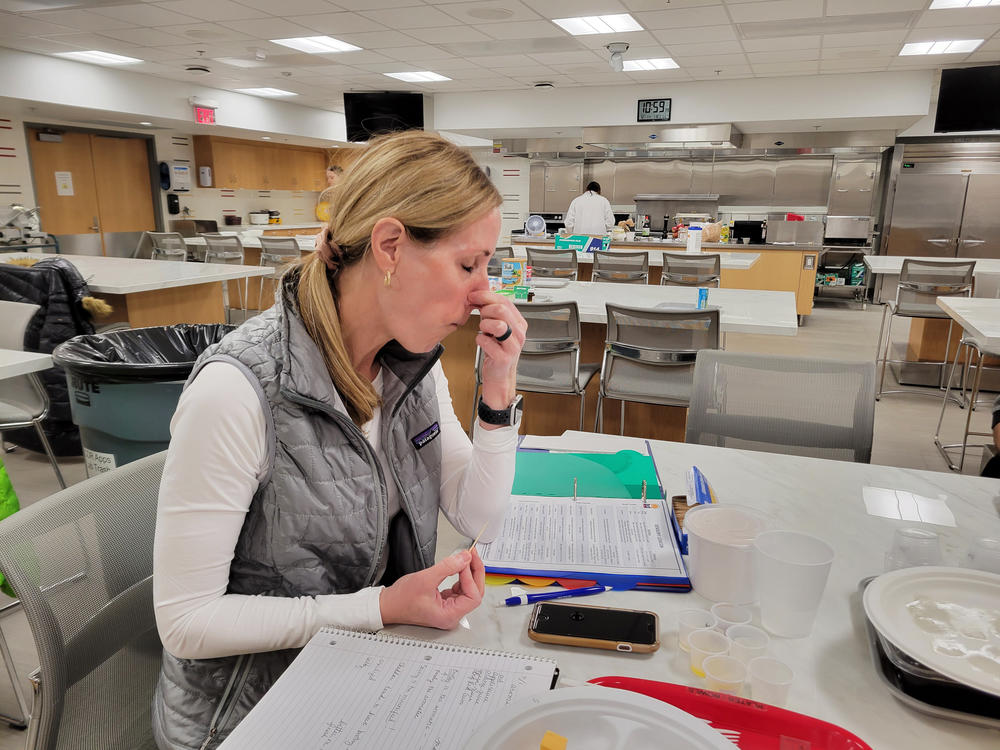 New taster Kelly Kluck plugs her nose as she tastes cheese. She has already earned a few wine tasting certifications.