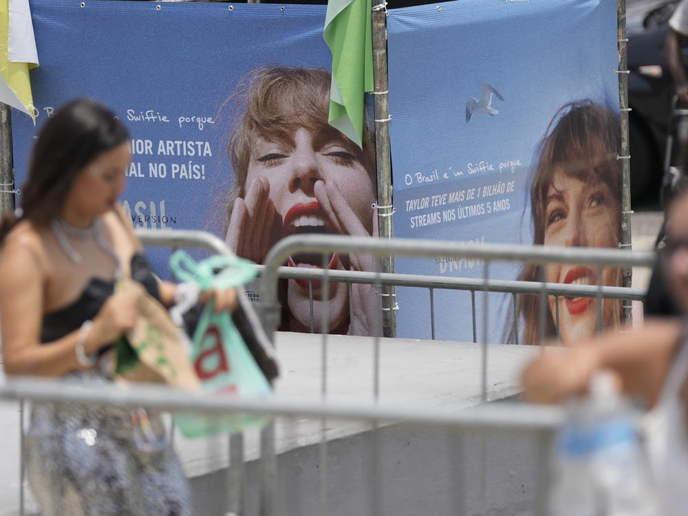 Taylor Swift fans wait for the doors of Nilton Santos Olympic stadium to open for her Eras Tour concert amid a heat wave in Rio de Janeiro, Brazil, Saturday, Nov. 18, 2023.