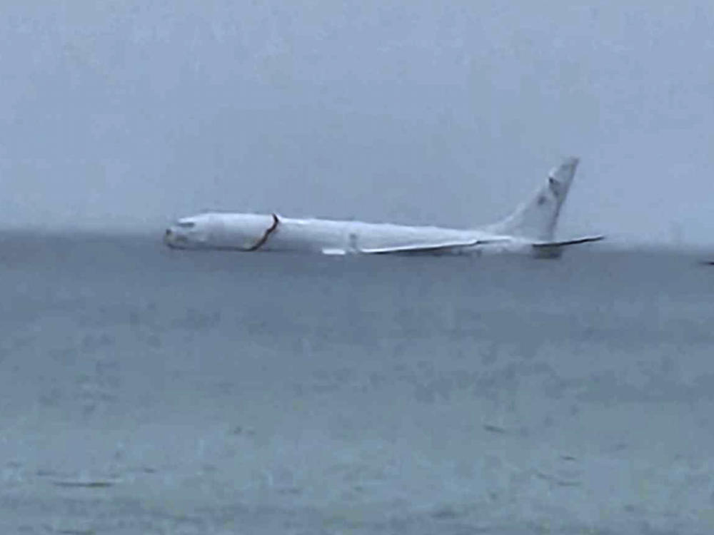 This photo provided by Diane Dircks shows a U.S. Navy plane that overshot a Marine base on Kaneohe Bay, Hawaii, Monday, Nov. 20, 2023. An official says all nine people aboard the plane have escaped injury.