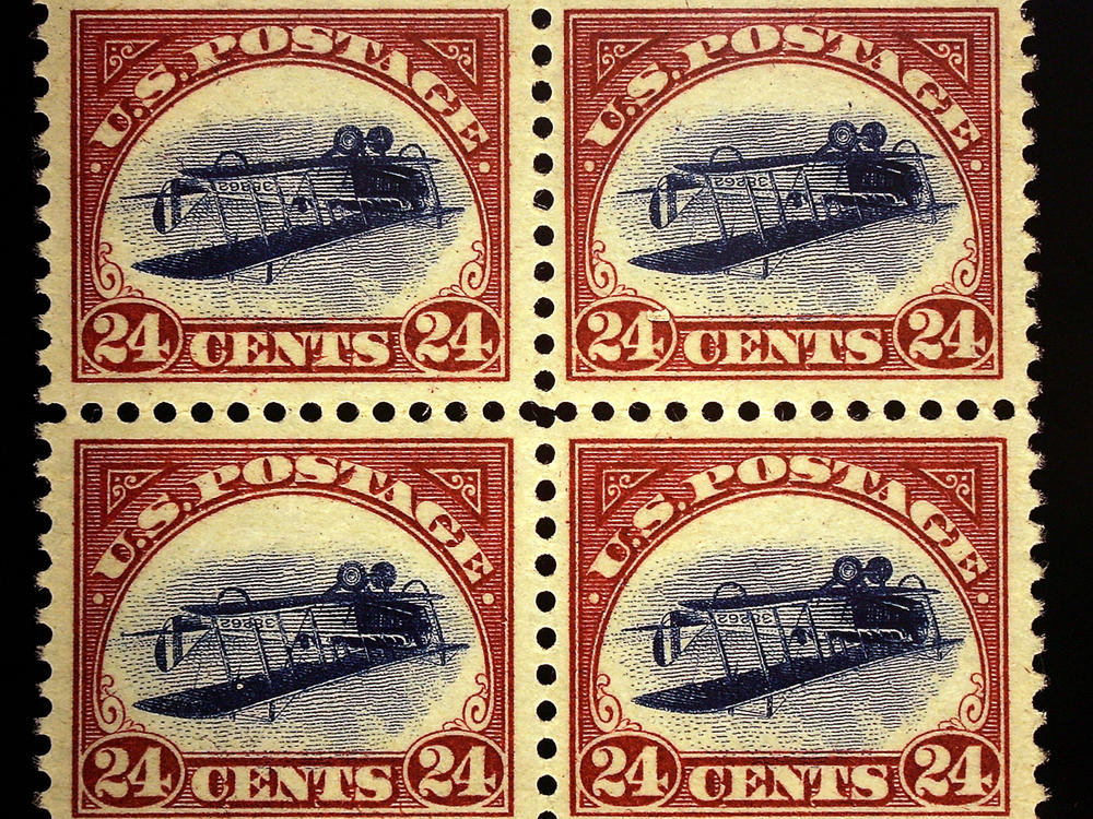 An enlarged replica of a block of four rare United States airmail error stamps, known as the Inverted Jenny plate block.