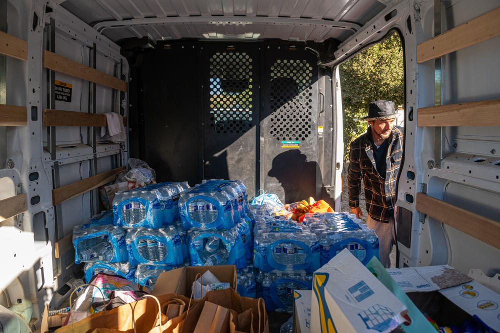 Dozens of volunteers based out of an old church youth center organize food and clothing supplies before heading out to the camps near Jacumba, Calif., on Nov. 11.
